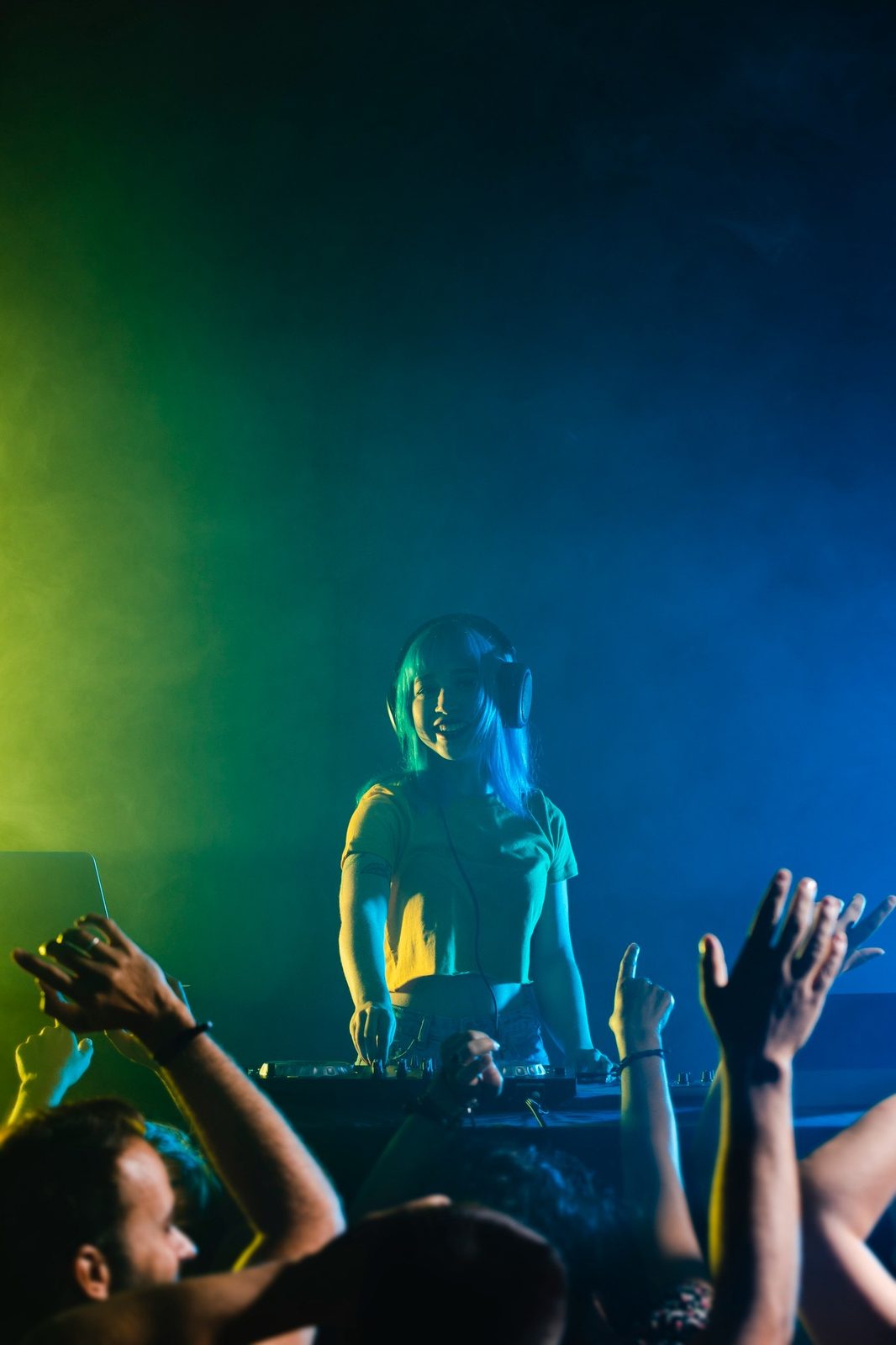 A DJ playing, hands up in front